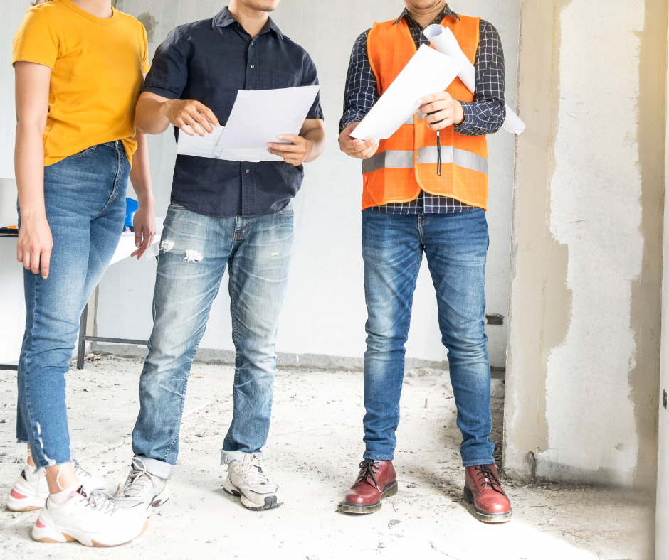 Home builder and home owners assessing plans